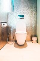 A bathroom with a toilet and a sink photo
