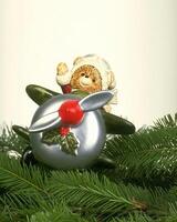 Festive Christmas Tree Adorned with Colorful Ornaments Behind a Window photo