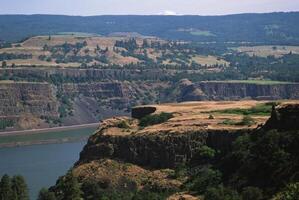 Majestic Mountain Landscape with Serene Water and Lush Vegetation Under a Clear Sky photo