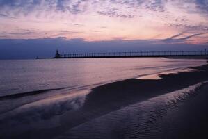 Tranquil Beach at Dusk. A Serene Azure Sky Reflecting in Water Afterglow photo