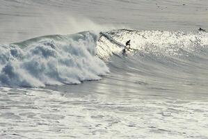 Thrilling Surfing Action on a Windy Day with Surfboards and Waves photo