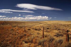 Serene Highland Landscape Under Cumulus Clouds and Expansive Sky photo