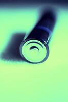 Close-Up of Battery in Abstract Cyan Lighting photo