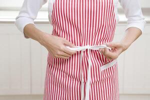 Woman tying apron strings photo