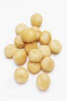 Raw Macadamia Nuts on Wooden Background photo