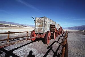 Rustic Highland Landscape with Automotive Tire and Wooden Fence under a Cloudy Sky photo