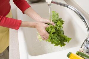 Woman washing lettuce photo