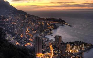 Serene Dusk Over Mountains and Buildings Beneath a Cloudy Sky photo