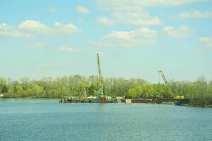 A boat with a crane on it in the water photo