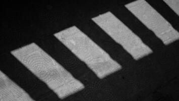 Vertical Lines Shadows on asphalt road Black and white pattern as background photo
