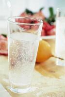 Refreshing Classic Cocktail served in a Highball Glass with Elegant Tableware and Water Accents photo