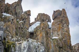 rocks waterfall and glacier at the Alkefjellet between Spitsbergen and Nordaustlandet on Svalbard, Norway photo