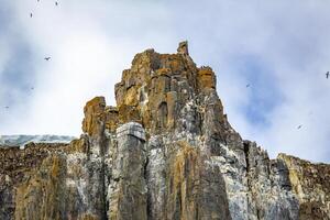 rocks waterfall and glacier at the Alkefjellet between Spitsbergen and Nordaustlandet on Svalbard, Norway photo