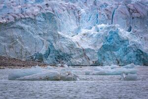 cruising in the Arctic in the Magdalensfjord on Svalbard along a glacier photo