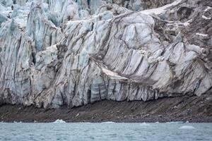 cruising in the Arctic in the Magdalensfjord on Svalbard along a glacier photo