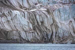 cruising in the Arctic in the Magdalensfjord on Svalbard along a glacier photo