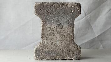 Textured concrete block on a light background photo
