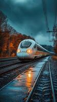 Modern high speed train traveling on railway at dusk in autumn photo