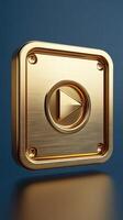 Golden play button shining on reflective surface with blue background photo