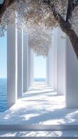 White colonnade overlooking tranquil ocean with flowering trees photo