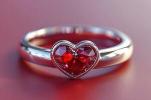 Heart-shaped diamond ring embracing a red gemstone on red background photo