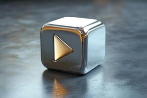 Metallic play button shining on reflective surface symbolizing online streaming photo