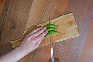 Chopping green peppers for salad. photo