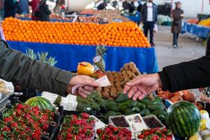 A man paying for shopping at a local market. photo