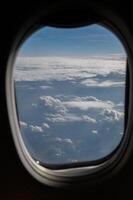 View of clouds and horizon from plane window. photo
