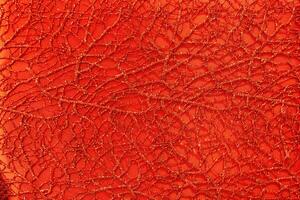 Red shiny lurex and patterned fabric texture. photo