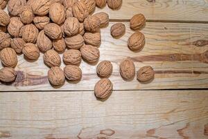 Walnuts on a wooden table. View from above. photo