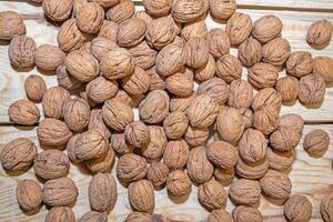 Walnuts on a wooden table. View from above. photo