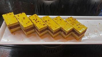 Sliced fresh cake in a restaurant window. photo