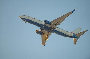A passenger plane landing. Passenger plane flying in the sky. Aircraft opening the landing gear. photo