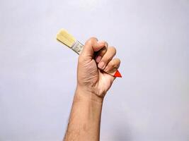 Hand Holding a Single Paintbrush Tool photo