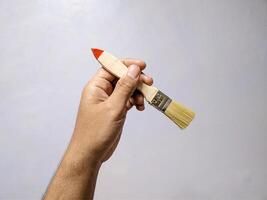 Hand Holding a Single Paintbrush Tool photo