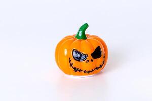 Spooky halloween pumpkin with scary face on white background photo