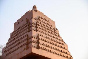 Arrangement of the carved stone buddha on pagoda photo