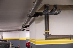 Underground Parking Garage With Visible Industrial Pipes photo