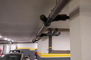 Underground Parking Garage With Visible Industrial Pipes photo