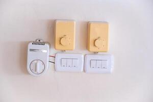 Wall-Mounted Switches and Thermostat Control Panel photo