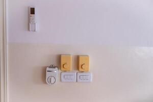Wall with Electrical Switches and Remote Control Panel photo