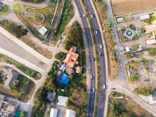 Traffic on highway with building and nature in evening