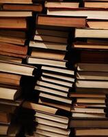 Pile of old dirty books on book shelf photo