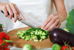 Hands of a woman cutting vegetables photo