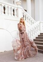 Beautiful blond woman in long dress photo