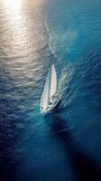 Sailing through azure waters among coastal reefs during a bright sunny day photo