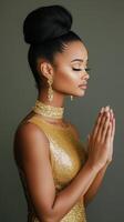 Young model in a sparkling dress poses elegantly with hands together against a shimmering background photo