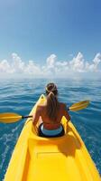 Bright yellow canoe floating on clear blue water under a sunny sky in a tropical paradise photo