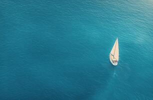 Sailing on calm blue waters with a lone boat under a sunny sky photo